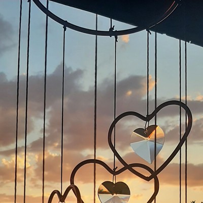 Sunset hanging metal hearts,