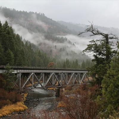 A railroad trestle over the Payette River north of Horseshoe Bend, Idaho, along Hwy 55 with foggy mists in the trees behind. Photo taken by Keith Collins on November 2, 2018.