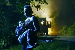 Hugh Jackman carries Dafne Keen in a scene from "Logan." -- Twentieth Century Fox via AP/Ben Rothstein