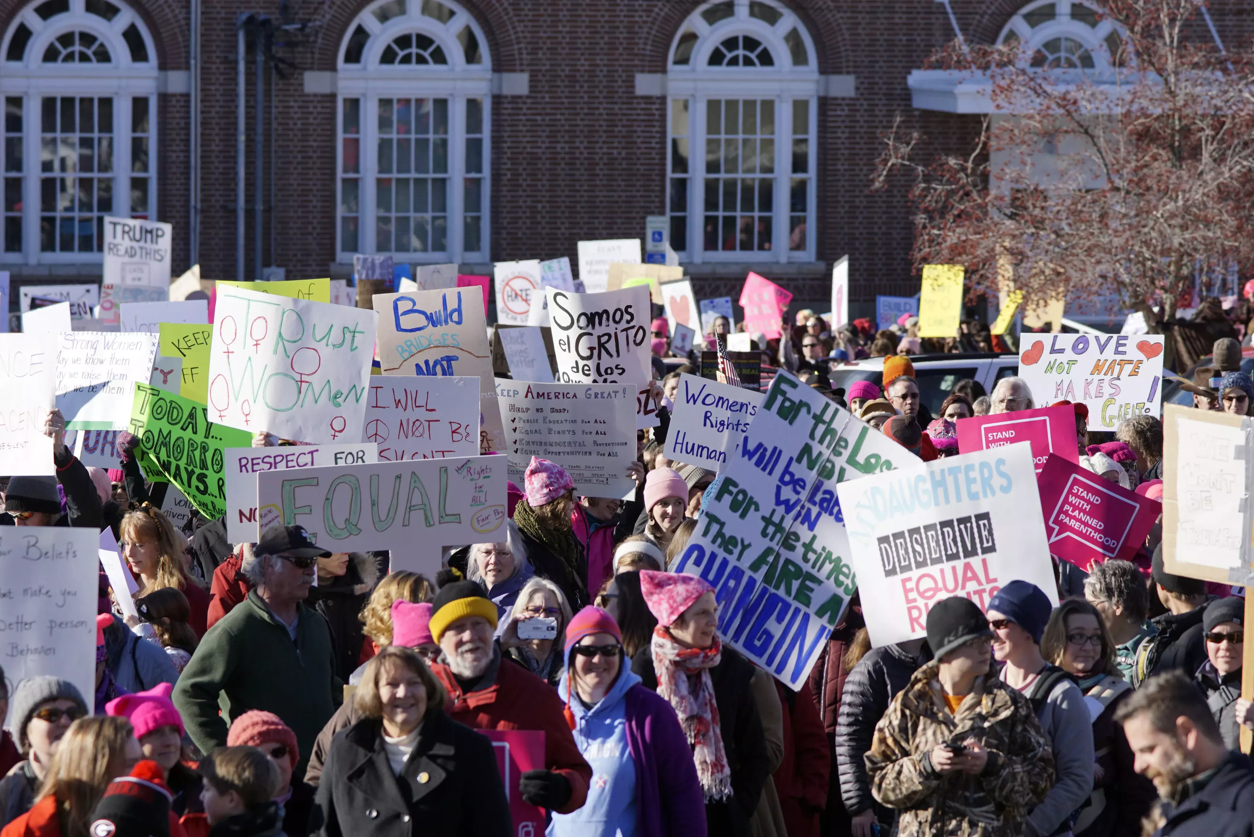 Marchers hold signs as they leave Moscow City Hall to walk to East City Park during the Women's March Saturday afternoon. - KAI EISELEIN