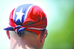 Don Elam wears a confederate flag bandana on his head at the 15th annual Redneck Games in East Dublin. Ga. on Saturday, July 9, 2011. The Games began in 1996 in conjunction with the Summer Olympics in Atlanta. The East Dublin Lions Club helps organize the Games and says all profits go to local charities. - AP PHOTO/MIKE STEWART