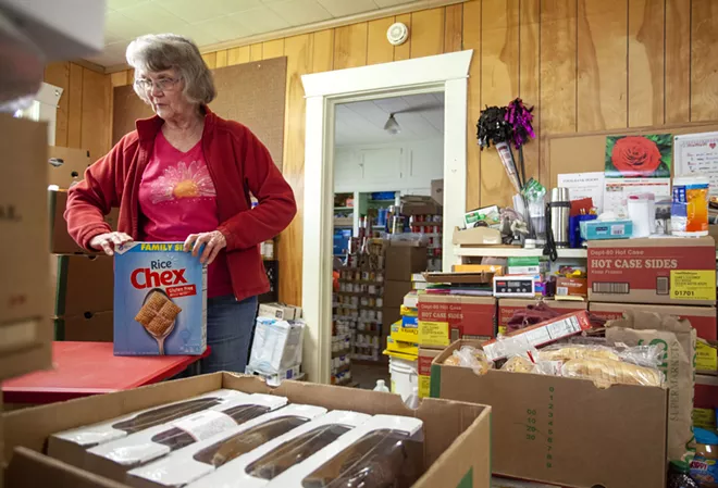 Director Linda Nickels organizes food on Tuesday before opening the Moscow Food Bank. Geoff Crimmins/Moscow-Pullman Daily News - GEOFF CRIMMINS/DAILY NEWS