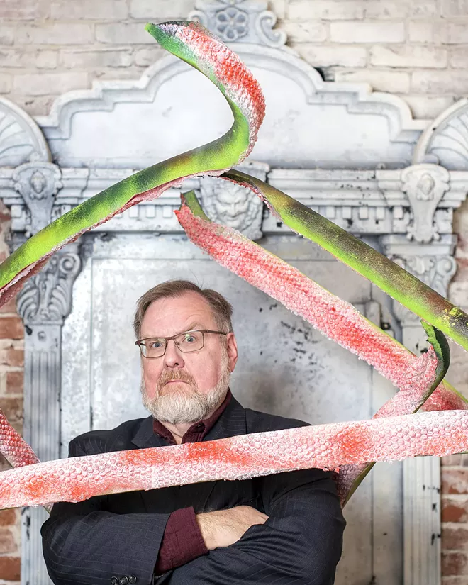 Alien tentacles that will be used as props in the show, surround Patrick Broemeling, who is directing a radio show production of "War of the Worlds" for the Lewiston Civic Theater, as he poses for a portrait inside the Lewis and Clark State College Center for Arts and History on Friday evening. - TRIBUNE/PETE CASTER