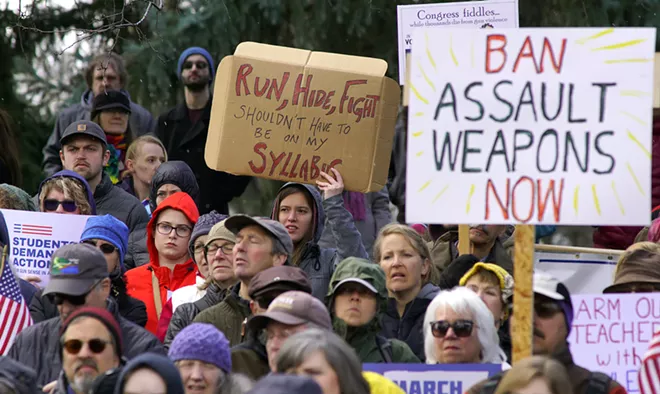 Protesters hold signs while listening to speakers at a March For Our Lives rally in Moscow's East City Park Saturday afternoon. - KAI EISELEIN