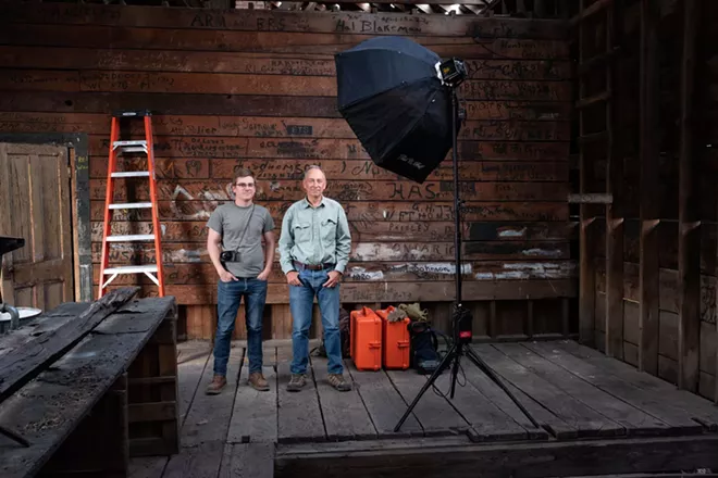 Charlie (left), Mike (right) amidst documenting a depot freight room covered in marks left by telegraphers and other railroad workers. Marks done with shipping crate ink and brush. Photo by Charlie Wray