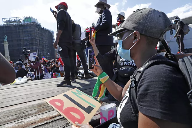 People record speakers and the crowd during a Caribbean-led Black Lives Matter rally at Brooklyn's Grand Army Plaza, Sunday, June 14, 2020, in New York. - AP PHOTO/KATHY WILLENS