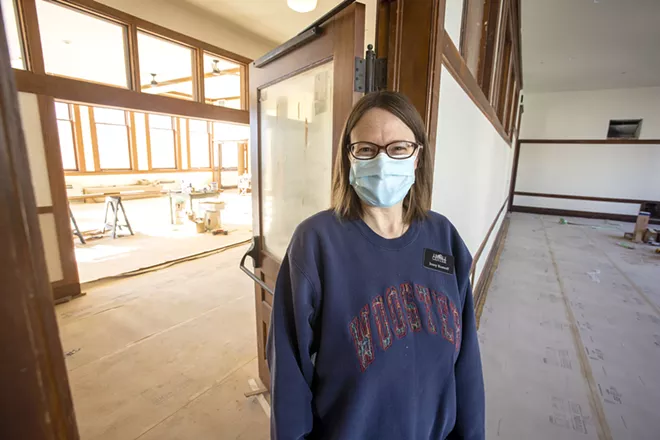 Heart of the Arts Executive Director Jenny Kostroff stand in the doorway to the Lecompte Auditorium, with the Reception Gallery across the hall in the background on Monday at the 1912 Center in Moscow. The two second-floor rooms are expected be finished in time to be used as addition space for the Winter Market on Nov. 14. - GEOFF CRIMMINS/DAILY NEWS