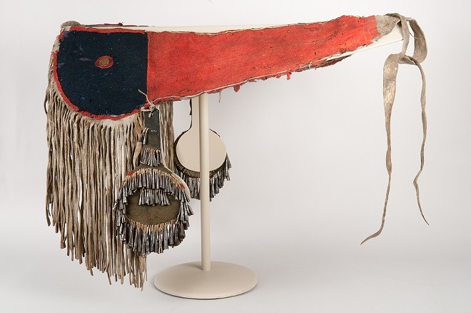 A cloth and fringe decorated horse crupper made of bison hide with cut and rolled tin cone jingles on two side attachments is part of the Spalding-Allen Collection. Photo Zac Mazur.