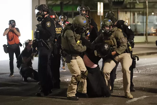 FILE - In this July 29, 2020, file photo, federal officers arrest a demonstrator during a Black Lives Matter protest at the Mark O. Hatfield United States Courthouse in Portland, Ore. An Associated Press analysis of more than 200 arrests shows that even those accused of breaking the law during the nightly rallies don’t neatly fit into President Donald Trump’s depiction of protesters as “anarchists and agitators.” - AP PHOTO/MARCIO JOSE SANCHEZ, FILE