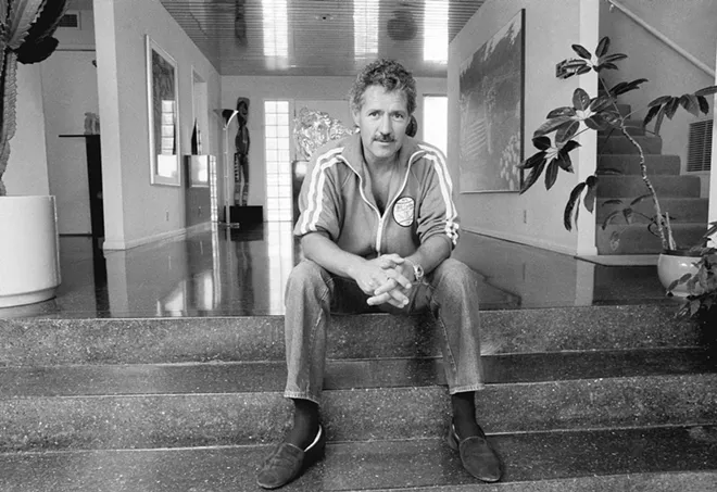 Game show host Alex Trebek poses for a photo in his Los Angeles home on Aug. 3, 1988. Trebek, who presided over the beloved quiz show ?Jeopardy!? for more than 30 years with dapper charm and a touch of school-master strictness, died Sunday, Nov. 8, 2020. He was 80. - AP PHOTO/ALAN GRETH