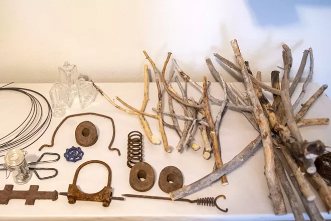 A table displays a collection of rusty materials and wood that Kristin LeVier has gathered around her remote cabin in Idaho near the Frank Church-River of No Return Wilderness. - ZACH WILKINSON