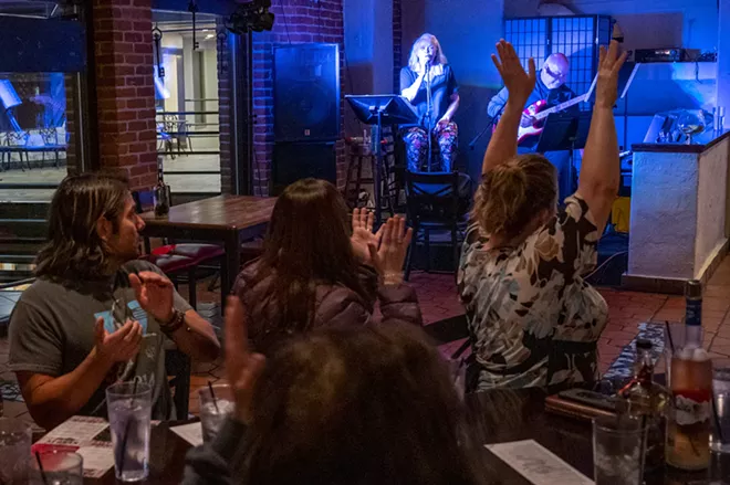 Sherry and Marty Lukenbill get an ovation after finishing a song during their second set on Friday, April 23, at Brock’s in downtown Lewiston. - PETE CASTER/360