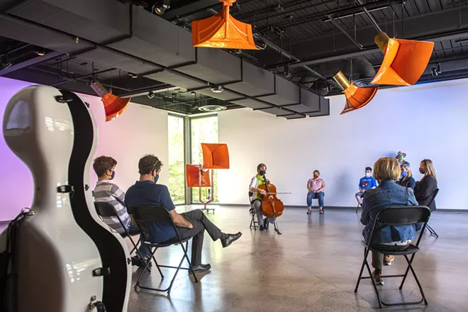 An audience surrounds Ruth Boden as she plays the cello in the Jordan Schnitzer Museum of Art pavilion at Washington State - University. Boden’s performance is in collaboration with Seattle-based artist, Trimpin’s, interactive sound sculpture called “Ambiente432,” which consists of 12 motion-responsive resonator horns. “The purpose of the music was to recenter and open up our minds to the fact that there is still live art and live music,” Boden said. - ZACH WILKINSON/INLAND 360