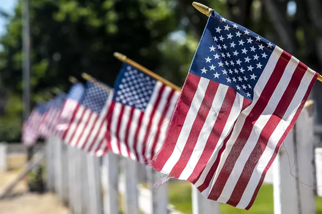 Flags fly along a fence line in Lewiston this week in anticipation of the July 4 holiday. - AUGUST FRANK