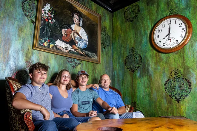 From left: Grant Stevens, 13, Caroline Stevens, 16, Jack Stevens, 17, and Geoff Stevens sit on a couch for a portrait at Mystic Cafe in Lewiston. - AUGUST FRANK/INLAND 360