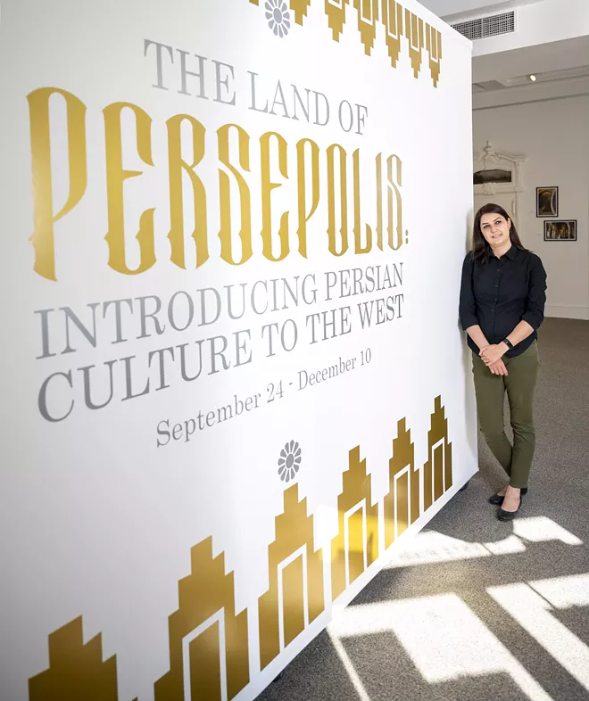 Tirazheh Eslami — an artist, faculty art professor at Lewis-Clark State College and exhibit coordinator — poses for a portrait in front of the entrance of the “Persepolis: Introducing Persian Culture to the West” sign on Thursday at the Lewis-Clark State College Center for Arts & History in downtown Lewiston. - PETE CASTER/360