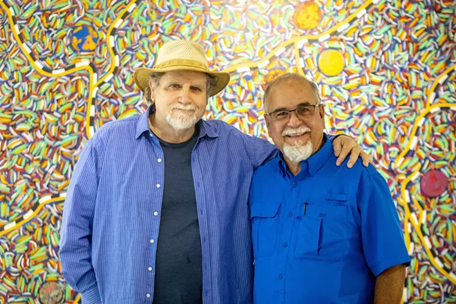 Ray Esparsen and Sean Cassidy stand in front of one of Esparsen’s paintings, titled “Maps of Place and Meeting” at the Lewis-Clark State Center for Arts & History exhibit as part of the Beautiful Downtown Lewiston's annual Artwalk. - AUGUST FRANK/360