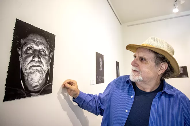 Sean Cassidy takes in his self-portrait at the Lewis-Clark State Center for Arts & History exhibit as part of the Beautiful Downtown Lewiston's annual Artwalk. - AUGUST FRANK/360