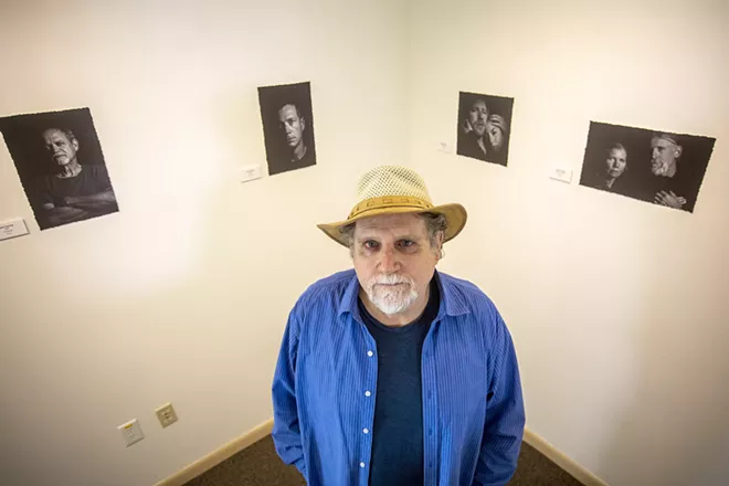 Sean Cassidy stands in front of his photographs at the Lewis-Clark State Center for Arts & History exhibit as part of the Beautiful Downtown Lewiston's annual Artwalk. - AUGUST FRANK/360
