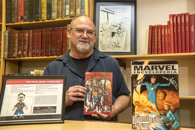 Surrounded by Marvel memorabilia, Mark O’English, an archivist at Washington State University, poses for a portrait inside the Terrell Library on Wednesday afternoon, Sept. 22, 2021. O’English previously worked for Marvel on the Fantastic Four completing encyclopedias. - ZACH WILKINSON/INLAND 360