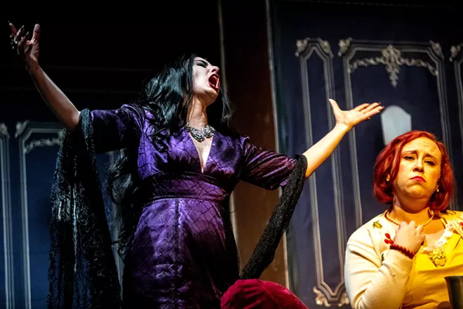Amy Stout, playing Morticia Addams, sings to Amanda Marzo, playing Alice Beineke, about honesty and marriage during a rehearsal for the Addams Family at the old Lewiston High School on Monday evening. - AUGUST FRANK/360