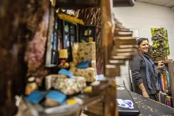 Jameton stands in her office at Lewis-Clark State College where a number of her miniature pieces are displayed.