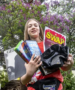 Eleanor Thompson, 9, holds an armful of various items for this weekend's The Swap. - AUGUST FRANK/INLAND 360