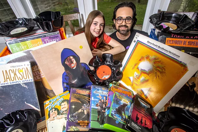 Will Thompson and his daughter Eleanor, 9, pose for a photo behind various items for The Swap, planned for Saturday in Clarkston. - AUGUST FRANK/INLAND 360