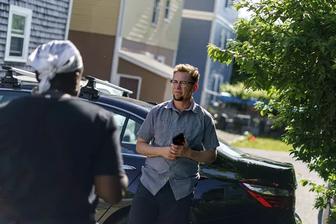 Scout, a transgender man who uses one name, talks to a neighbor outside his home in Providence, R.I., last week. “There’s no question I’m absolutely made invisible by the census,” Scout said. - AP DAVID GOLDMAN