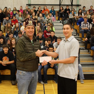 Pomeroy High School sophomore Cort LaMunyan, right, hands a check for $784.69 to Shrine member Bob Cox at a school assembly Dec. 15. The donation will go to the Pomeroy chapter of the Shriners. Cort helped raise the money by planning, organizing and carrying out two youth basketball tournaments in Pomeroy in November. Cort&#146;s brother, Cody, a freshman at Washington State University, who was diagnosed with diabetes at the age of 15, conceived and implemented the idea for the tournaments two years ago. Cort is carrying on the tradition in his name. Cort has been a patient at the Shriner&#146;s Hospital (as have many Pomeroy families) and has benefitted from their generosity. Cort is the son of Jan Baune and Doug LaMunyan. (Mike Tom photo)