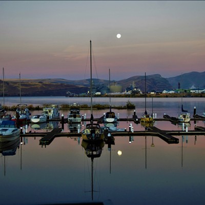 At sunrise on October 6, 2017. The moon was still bright in the sky and the reflection could be seen in the water among the boats at the docks in Clarkston. Taken by Mary Hayward.