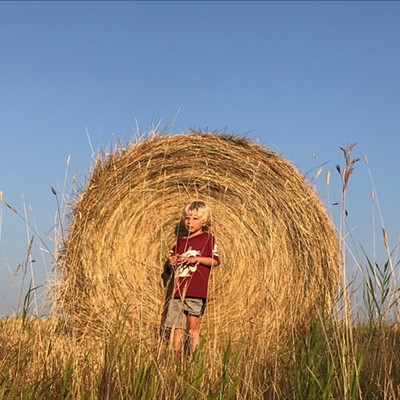 Reed, 4, stands in front of a hay bale off Teare Rd., Moscow, on Aug. 5, 2018. Reed is the son of Erika and Guy Wallin and grandson of&nbsp;Verna and Steve Bergmann. Erika Wallin snapped the photo.