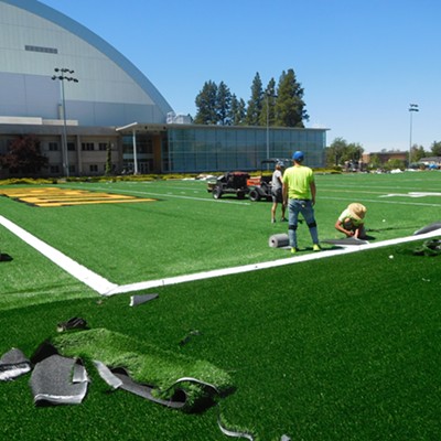 For the past couple weeks, a new outdoor practice field surface is being installed at the University of Idaho for the football team.  The new carpet covers a 540-foot-long marked playing field.  In this picture they are trimming and gluing down the new carpet near the Kibbie Dome on Friday 6-18-21.