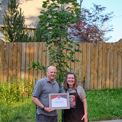 Retiring City of Pullman Police Chief Gary Jenkins is presented with a Good Neighbor Award and a tree planted in his honor at the College Hill Association's annual neighborhood barbecue on June 30. Allison Munch-Rotolo made the presentation on behalf of the group. By tradition, the Good Neighbor Award is presented to nonresidents of College Hill who make significant contributions toward improving the quality of public life in the neighborhood.