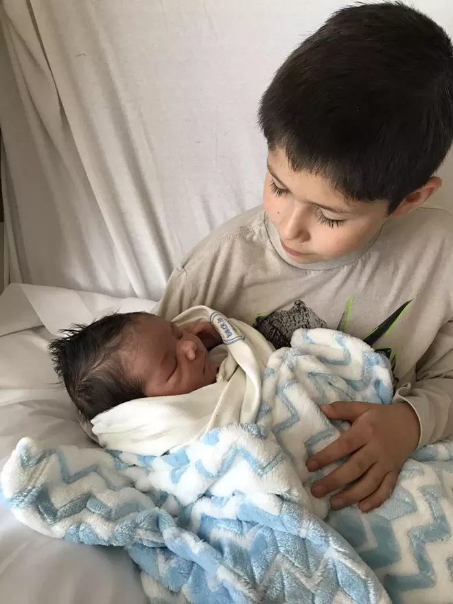 Big brother holding baby brother