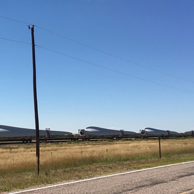 Each blade takes up two flatcars. These blades are heading east along Rt 40 In eastern Colorado. August 21. Taken by Sarah Walker