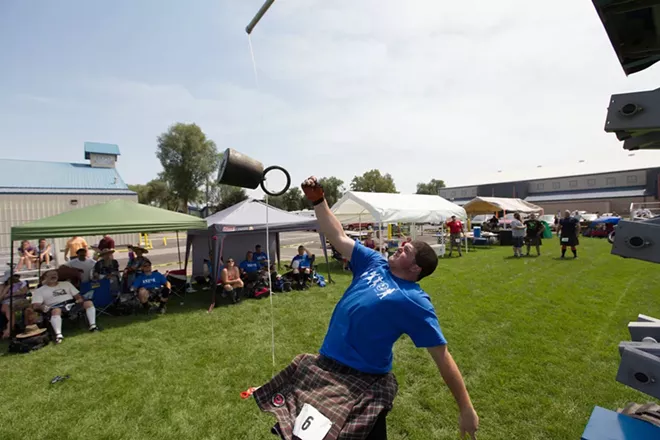 Kobie Hamm, 17, from Sandy, Ore., attempts a weight over a bar during the men's amateur A & B competition. - YOUNG KWAK