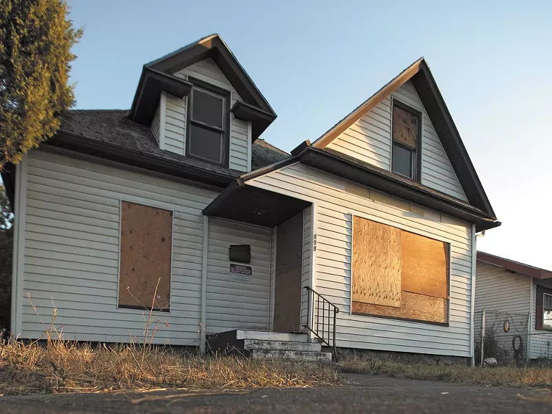 A boarded-up home owned by the city of Spokane.