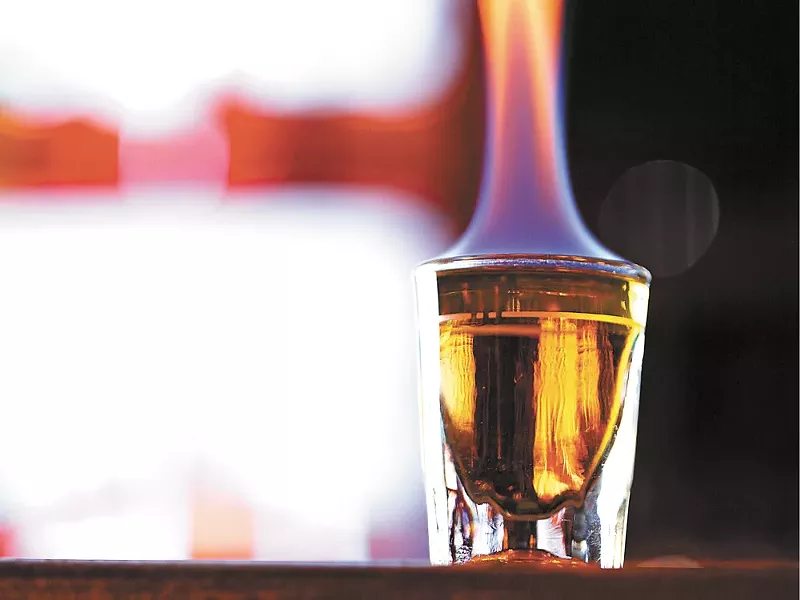 A shot of Fireball lights up the bar top at NYNE. - YOUNG KWAK
