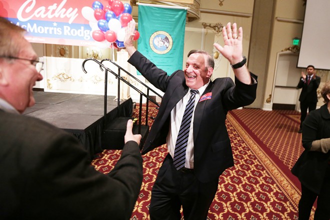 After the first election results show him with a 17 point lead over his rival Breean Beggs (D), not pictured, Spokane County Prosecuting Attorney candidate Larry Haskell (R), right, celebrates with Spokane County Republican Party Chair Dave Moore. - YOUNG KWAK