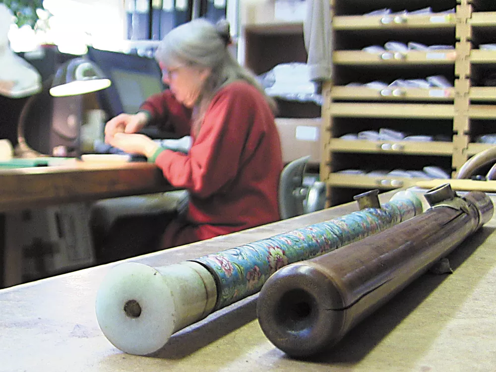 An enamel-decorated opium pipe, recently donated to the University of Idaho, rests next to one made of bamboo as Priscilla Wegars catalogs other opium artifacts. - ERIC FRANCAVILLA