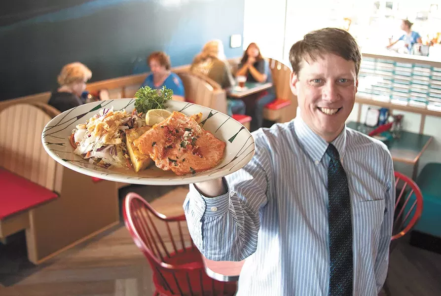 Anthony's Beach Cafe General Manager Andrew Miller shows off cuisine at the newly opened South Hill seafood spot. - ASHLEY TOMLINSON