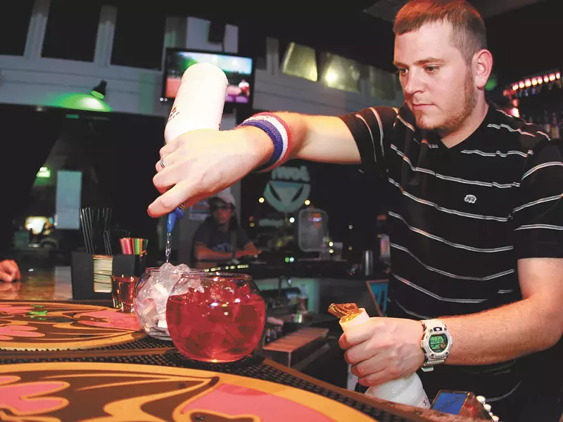 Bowl’z co-founder Jake Miller whips up one of bar’s signature drinks. - JOE KONEK
