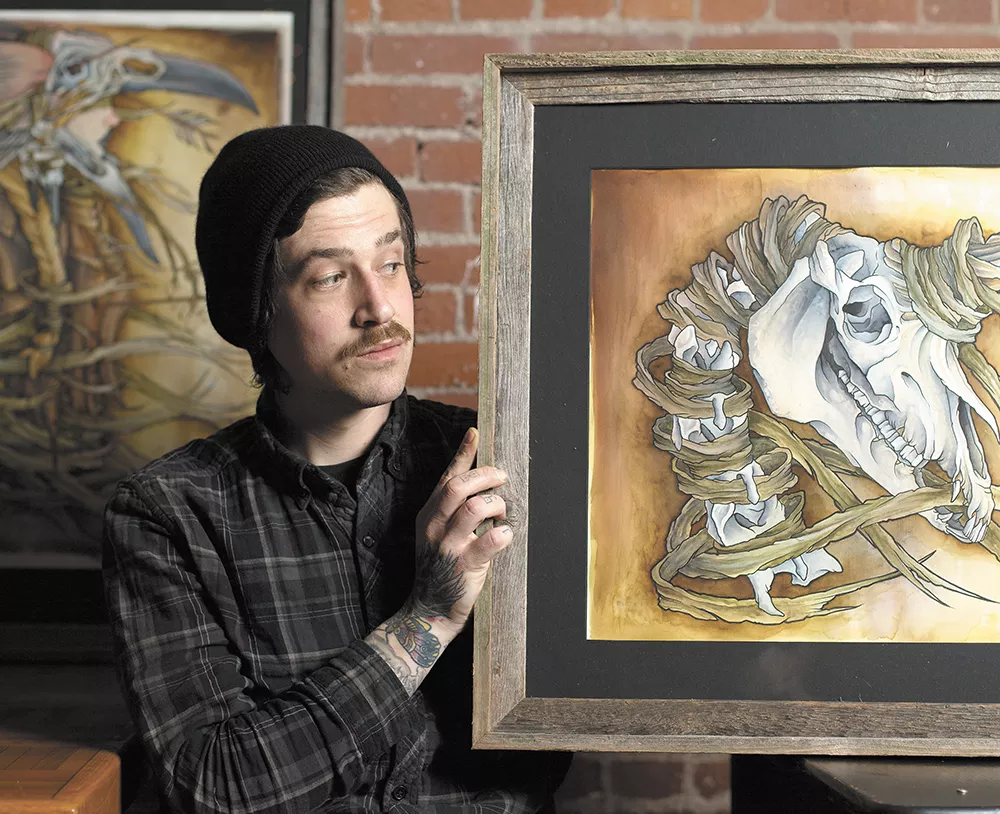 Brian Houghton with "The Last Unicorn" (right) and "The Last Valkyrie," both of which are hanging at Stella's Cafe in Spokane. - YOUNG KWAK