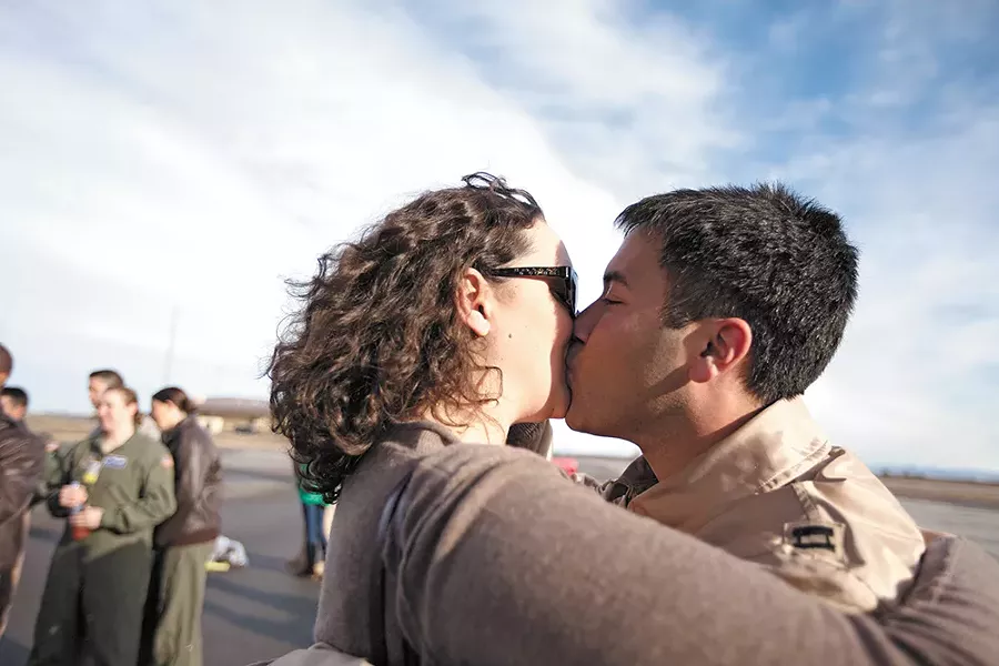 Capt. Ariel Kayne kisses his wife, Sara, for the first time in three months, at Fairchild Air Force Base. - YOUNG KWAK