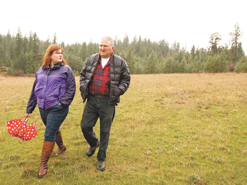 Cassie Price, left, and her father, Ross Taylor, walk their family property in Spokane Valley. - YOUNG KWAK