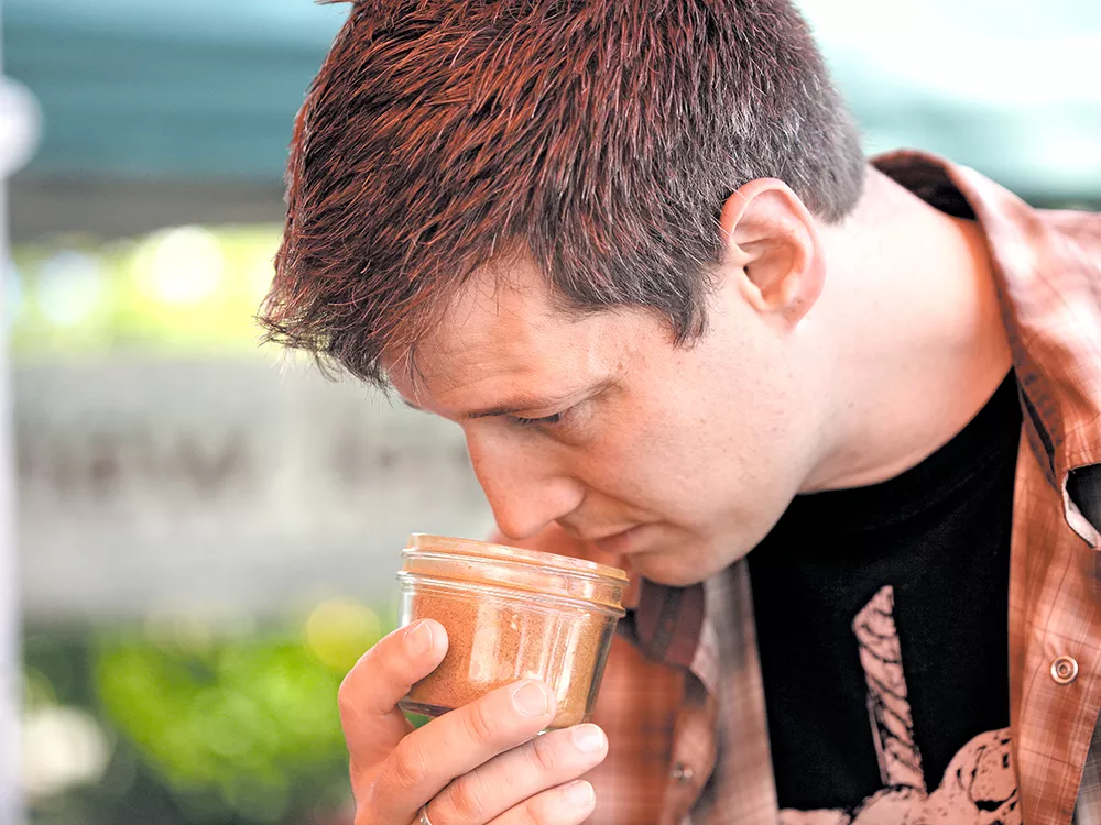 Chef Jeremy Hansen sniffs spice mixes at SavorX before settling on owner/chef Pete Taylor’s Tandoori Glory Morrocan Rub. - YOUNG KWAK