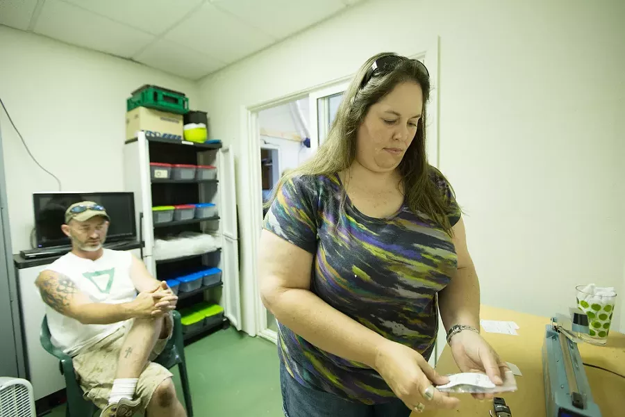 Co-Owner Johanna Tuttle, right, creates one gram bags of New York City Diesel marijuana while her husband and Co-Owner Wesley Tuttle looks on. - YOUNG KWAK