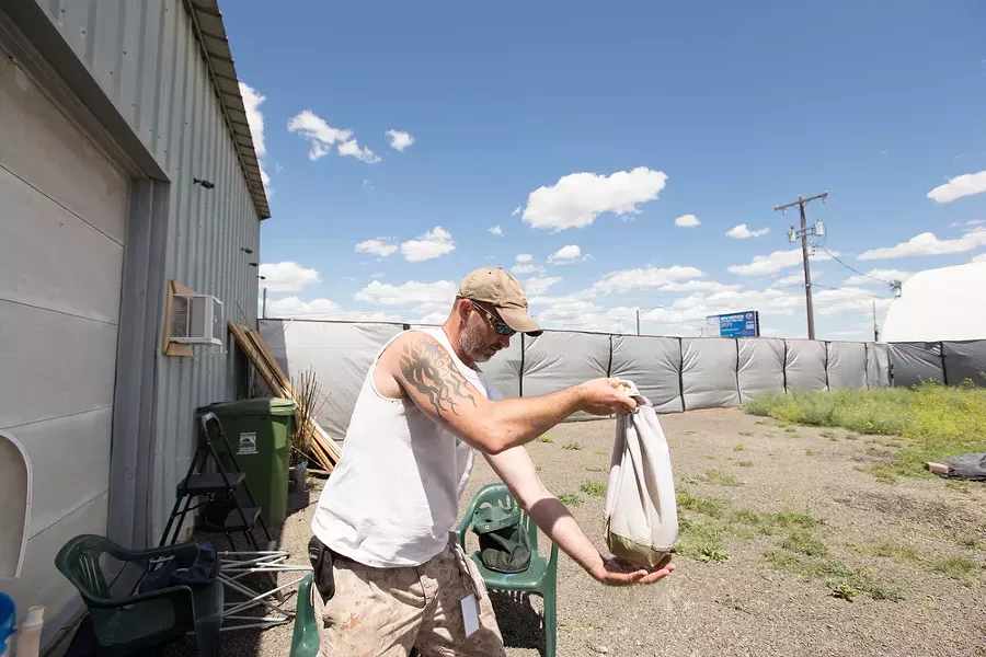 Co-Owner Wesley Tuttle shakes a bag of water before drying the hash contained within. - YOUNG KWAK