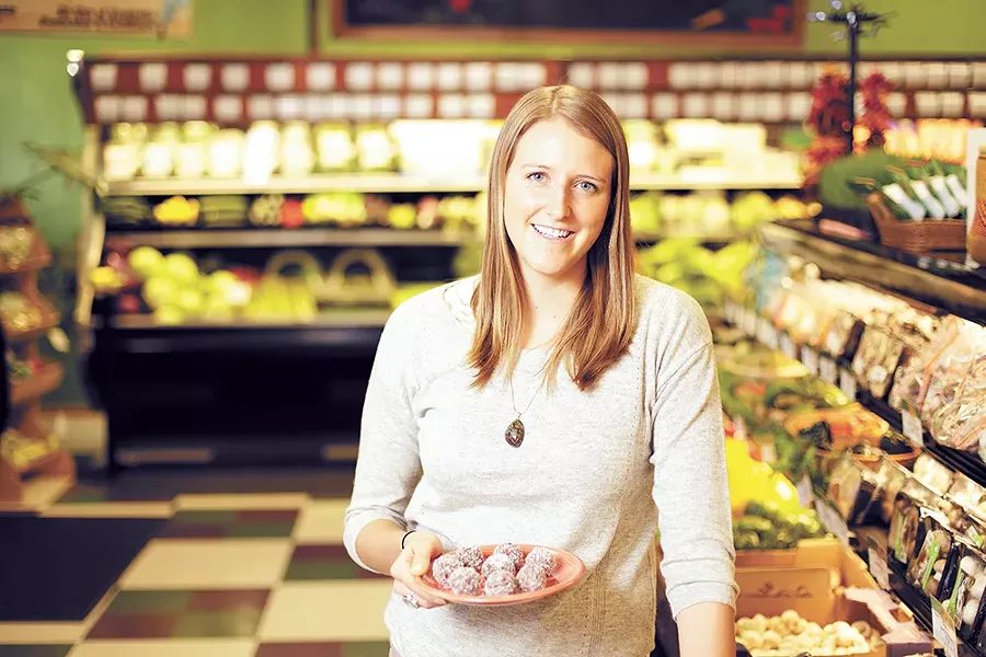 Darci Barman with a plate of cranberry pecan energy balls at Pilgrim's Market in Coeur d'Alene. - YOUNG KWAK